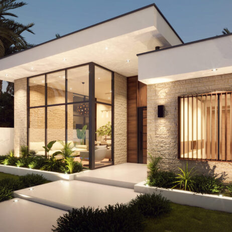 Fachada lateral de una casa moderna de un piso con grandes ventanales y jardinería iluminada, parte del proyecto de Planos de casa de 1 piso Porta.