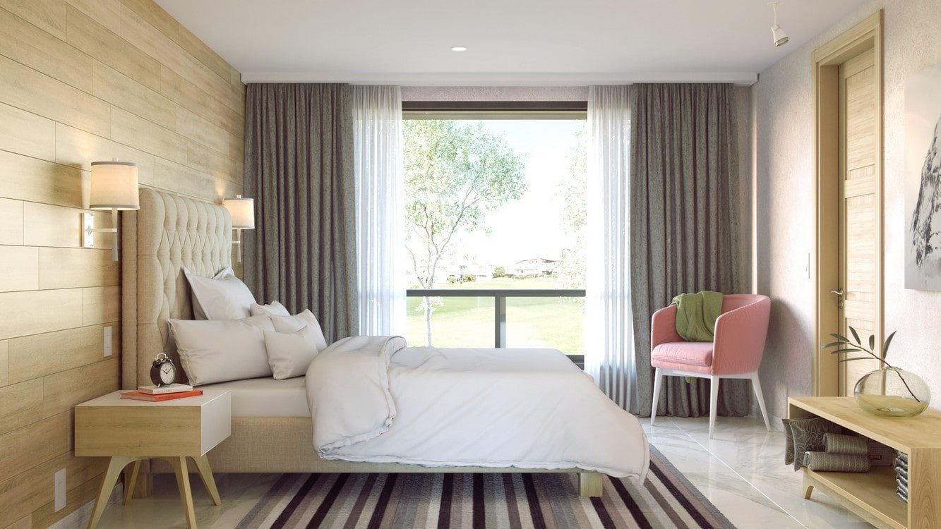 Dormitorio de la Casa de 10x20 moderna mod. Arce con cama doble, cabecera tapizada, ventanal y sillón rosa