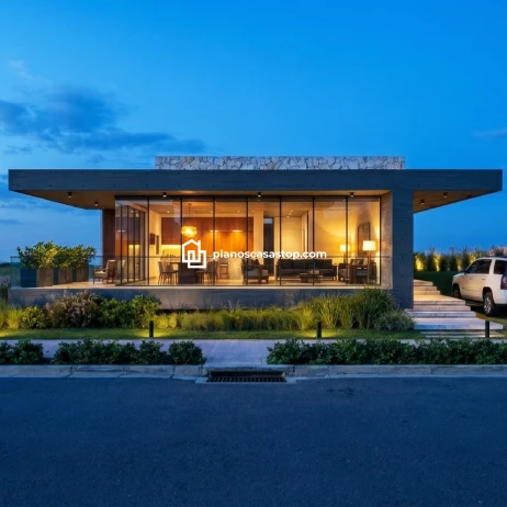 Diseño y Planos de Casa Moderna Viesca: Lujo y Transparencia Fachada de cristal y concreto según los planos de casa moderna Viesca con iluminación cálida al atardecer.