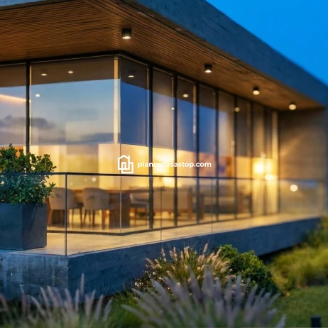 Planos de casa moderna Viesca: Diseño Contemporáneo Terraza iluminada al atardecer según los planos de casa moderna Viesca con grandes ventanales y barandal de vidrio.