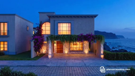 Fachada de casa colonial Sauce con paredes de piedra y bugambilias frente al mar durante el atardecer con luces cálidas.