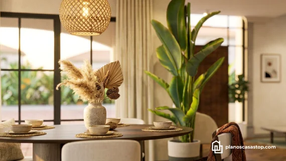 Comedor con lámpara de mimbre y plantas integradas en los planos de casa colonial jazmín.