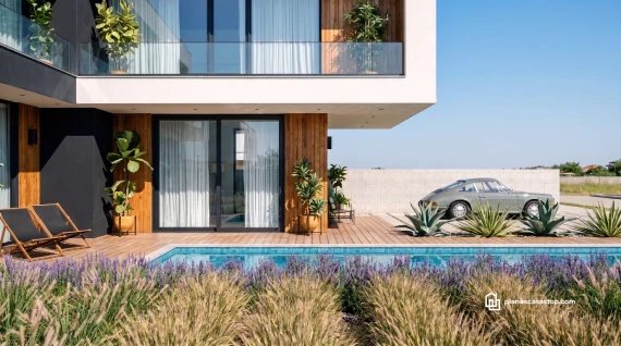 Fachada moderna de planos de casa de 2 pisos CBAM con piscina, deck de madera y jardín contemporáneo bajo luz natural.